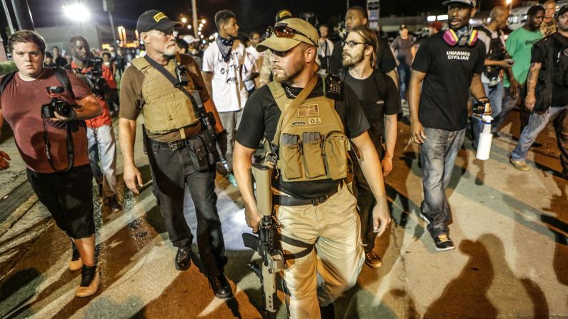 Members of a group calling themselves the "Oath Keepers" appear in Ferguson carrying large guns on Monday, August 10, one day after a police confrontation led to a protester being shot. Sunday, August 9, marked the one-year anniversary of the death of Michael Brown.