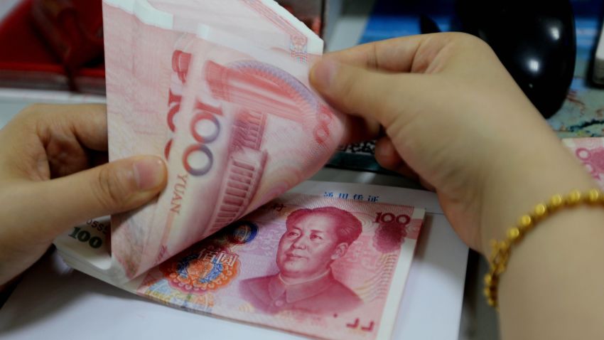 A teller counts yuan banknotes in a bank in Lianyungang, east China's Jiangsu province on August 11, 2015. China's central bank on August 11 devalued its yuan currency by nearly two percent against the US dollar, as authorities seek to push market reforms and bolster the world's second-largest economy. CHINA OUT AFP PHOTOSTR/AFP/Getty Images