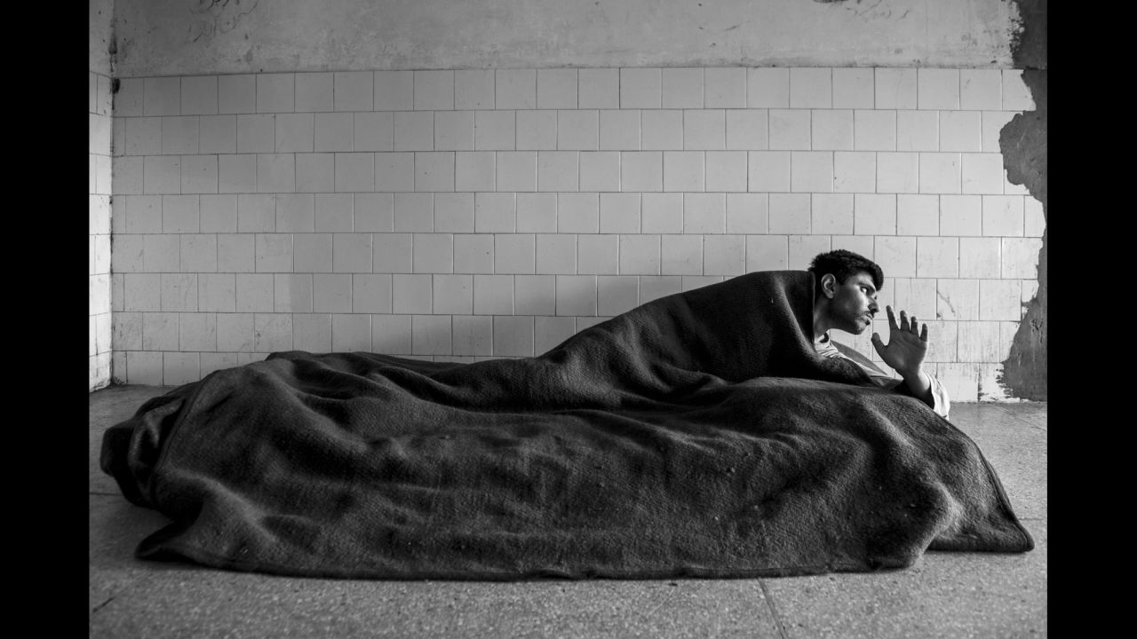 A man lies on a mattress in the hospital's chronic patients ward.