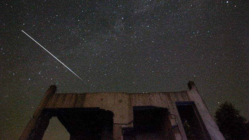 Stars and meteor streaks are seen behind a destroyed house, near Tuzla, Bosnia, August 12. 