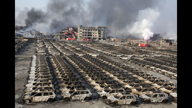 Smoke from the explosion billows over destroyed cars. As of 2014, Tianjin was the world's 10th-busiest container port, <a href="index.php?page=&url=http%3A%2F%2Fwww.worldshipping.org%2Fabout-the-industry%2Fglobal-trade%2Ftop-50-world-container-ports" target="_blank" target="_blank">according to the World Shipping Council</a>.