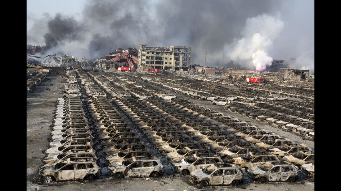 Smoke from the explosion billows over destroyed cars. As of 2014, Tianjin was the world's 10th-busiest container port, <a href="http://www.worldshipping.org/about-the-industry/global-trade/top-50-world-container-ports" target="_blank" target="_blank">according to the World Shipping Council</a>.