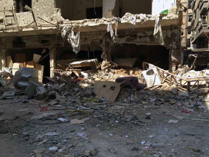 The personal belongings of people who fled Yarmouk long ago lay strewn amongst the wreckage, blackened by bombs that have reduced most of the district to rubble.