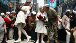 Carl Muscarello and Edith Shain -- among those who have claimed to be the nurse and sailor in the famous V-J Day photo -- kiss next to a sculpture based on the photo in Times Square on  August 14, 2005.  (Photo by Mario Tama/Getty Images)