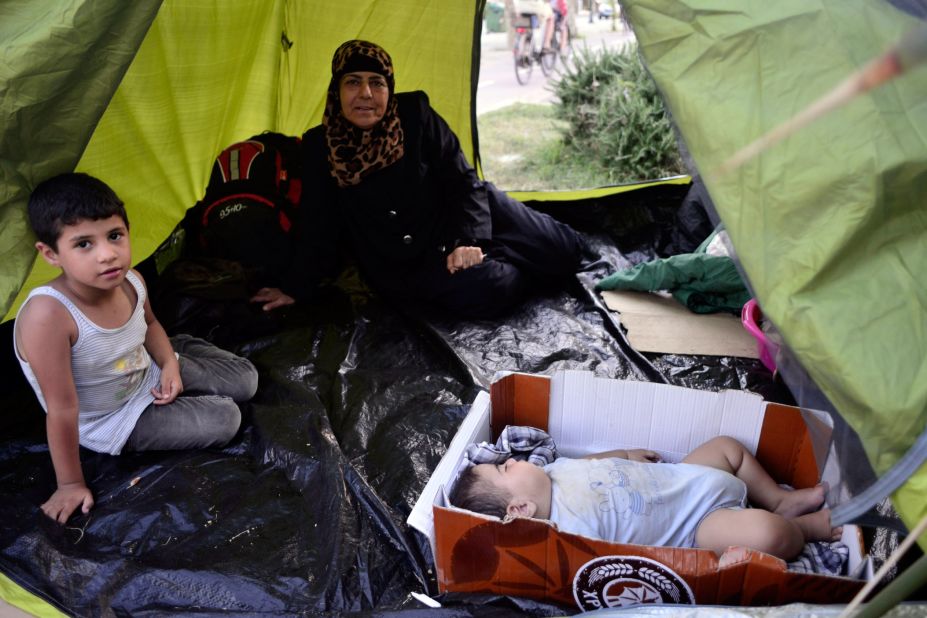 A Syrian family takes shelter at a makeshift camp in the center of town on August 12.
