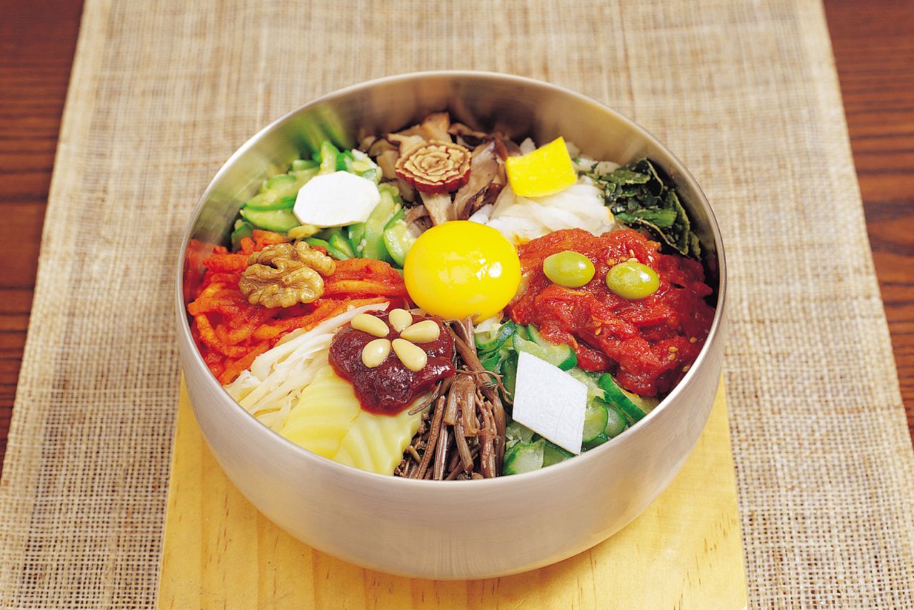Bibimbap combines rice, vegetables and eggs with a spicy sauce.