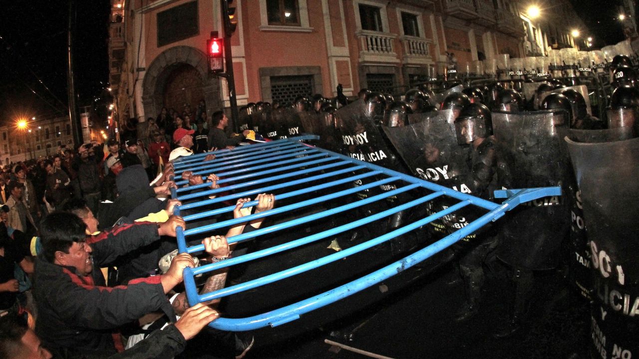 Demonstrators clash with the riot police in Quito, on August 13, 2015, during a strike organized by opposition indigenous groups and unions. Demonstrators took to the streets around Ecuador on Thursday to protest against President Rafael Correa's moves to seek a fourth term, but the leftist leader declared that plans for a paralyzing general strike had failed. Indigenous protesters, who have been particularly vocal critics of Correa, blocked roads in six of Ecuador's 24 provinces, including the Pan-American Highway to Peru, officials said.