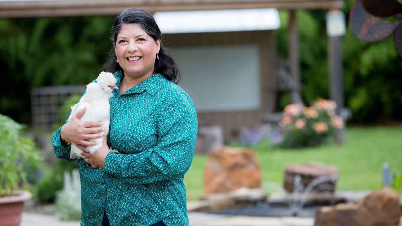 Margie Hernandez, principal of Pershing Elementary School in Dallas, Texas, holds one of the school garden's resident chickens.