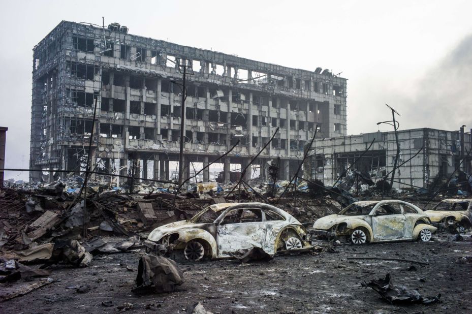 Volkswagens lie burned near ruined buildings on Friday, August 14.