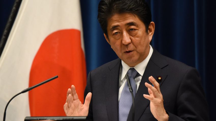 Japanese Prime Minister Shinzo Abe gestures as he answers questions following his war anniversary statement that neighbouring nations will scrutinise for signs of sufficient remorse over Tokyo's past militarism at his official residence in Tokyo on August 14, 2015.