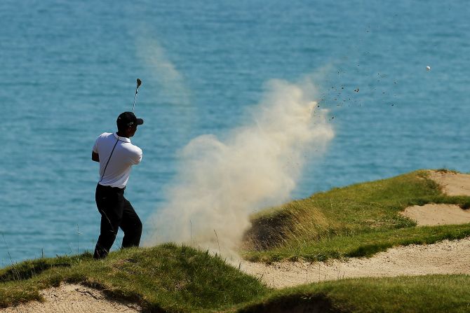 Tiger Woods is battling to make the halfway cut, and has five holes to play when the second round is resumed Saturday morning.