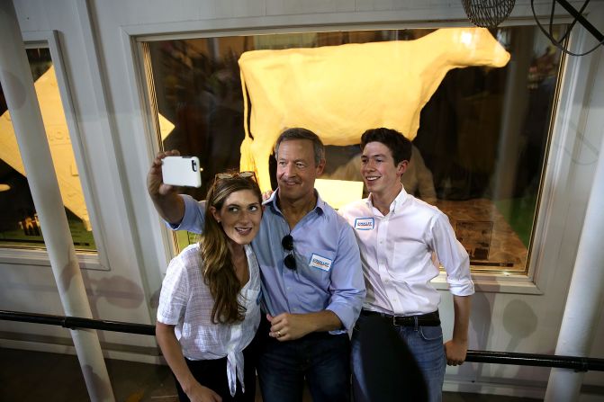 O'Malley takes a selfie in front of the butter cow with his children Grace and William on August 13.