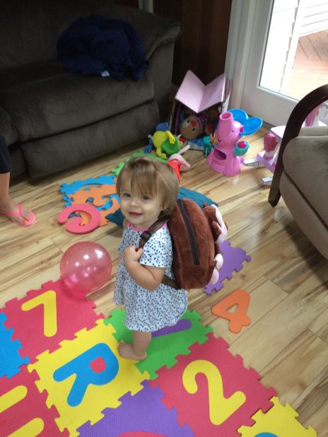 Fourteen-month-old Zoey of Newburgh, New York, tries on her first backpack, courtesy of her grandma. 