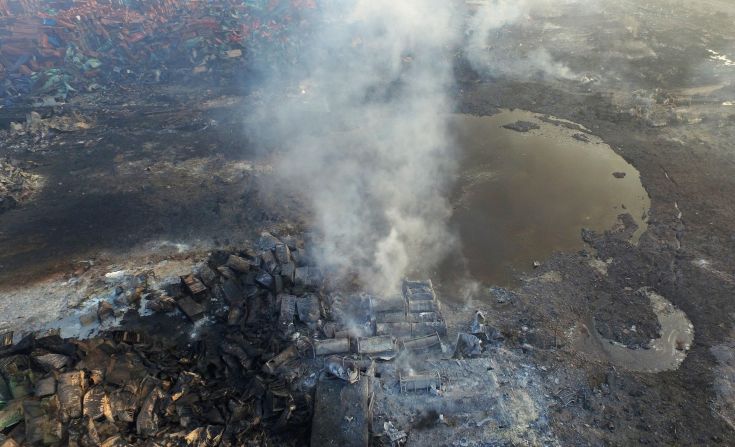 Smoke rises from debris on August 15 near a crater at the center of where the explosions took place.