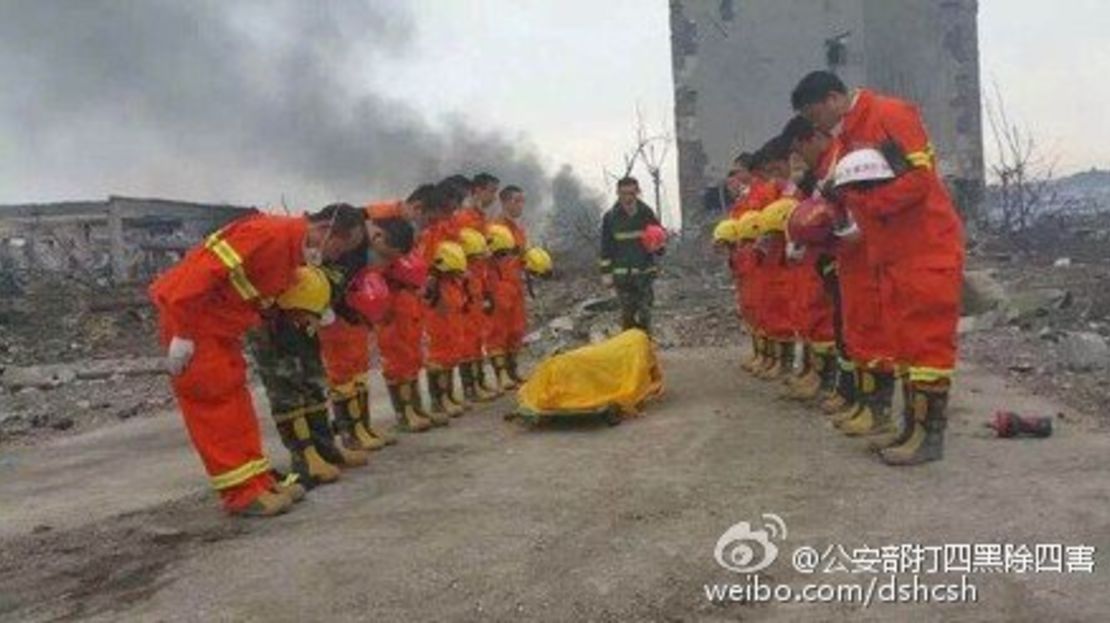 Chinese firefighters mourn their comrade who died in battling the fire and explosions in Tianjin.