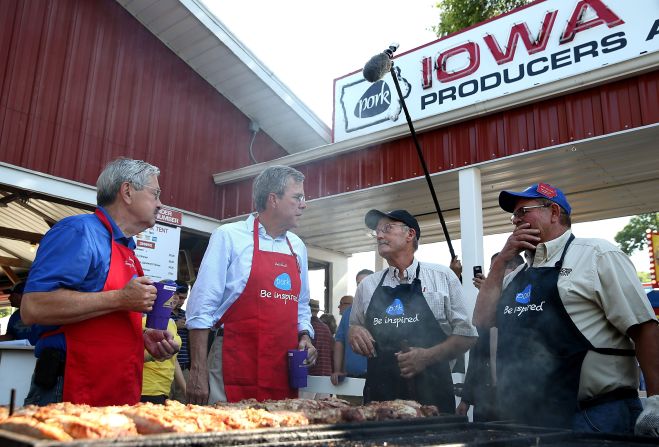 From left, Iowa Gov. Terry Branstad and Republican presidential hopeful Jeb Bush talk with pork producers on Friday, August 14.