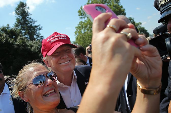 Trump greets fairgoers while campaigning on August 15.