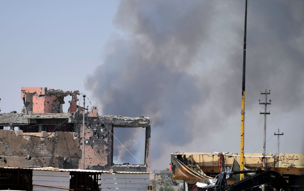 Smoke rises above a damaged building in Ramadi, Iraq, following a coalition airstrike against ISIS positions on Saturday, August 15.