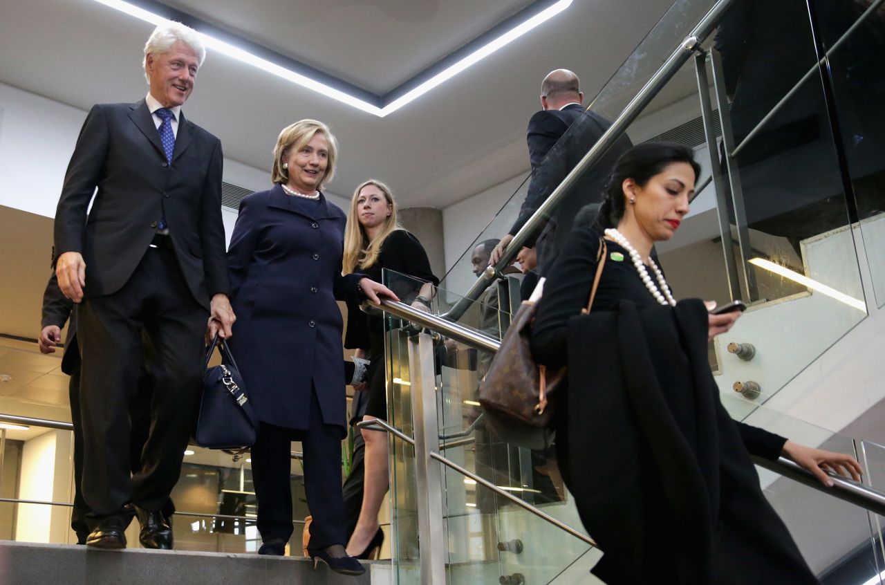 (Left to right) Former U.S. President Bill Clinton, former Secretary of State Hillary Clinton, their daughter Chelsea Clinton and Abedin leave the official memorial service for former South African President Nelson Mandela at FNB Stadium December 10, 2013 in Johannesburg, South Africa. 