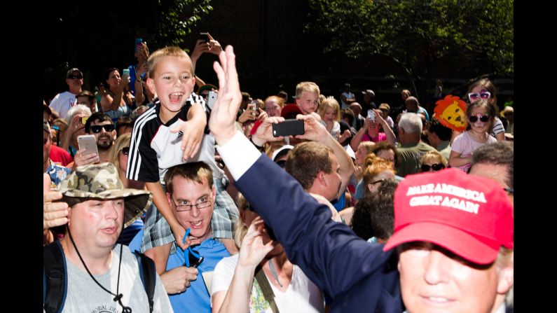 After a short chat with the media, Trump enters the fairgrounds, where he was mobbed by hundreds of fairgoers who wanted to shake his hand or just snap a photo of him. He was closely guarded by a half-dozen security guards and another 10 police officers, a mix of local cops and state troopers.