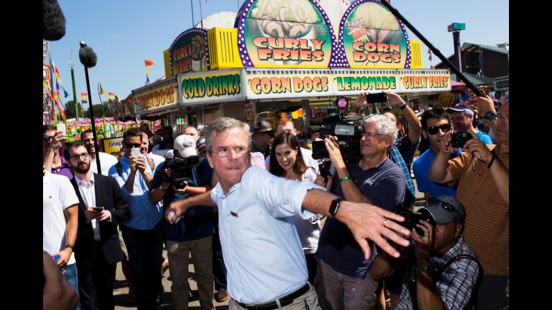 Bush prepares to throw a baseball in front of a crowd. 