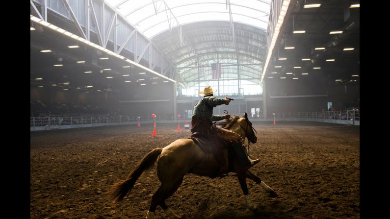 Brian Bolton, a Republican from Creston, Iowa, participates in a Cowboy Mounted Shooting competition.