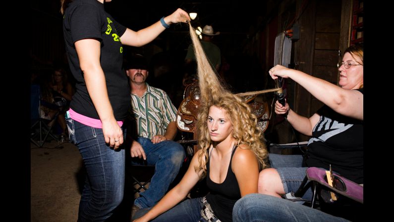 Shelby Heston, 16, from Fairfield, Iowa, gets prepped for the Cowgirl Queen competition. Her mother, Krista Heston (right), says she is voting Republican no matter who gets the nomination.