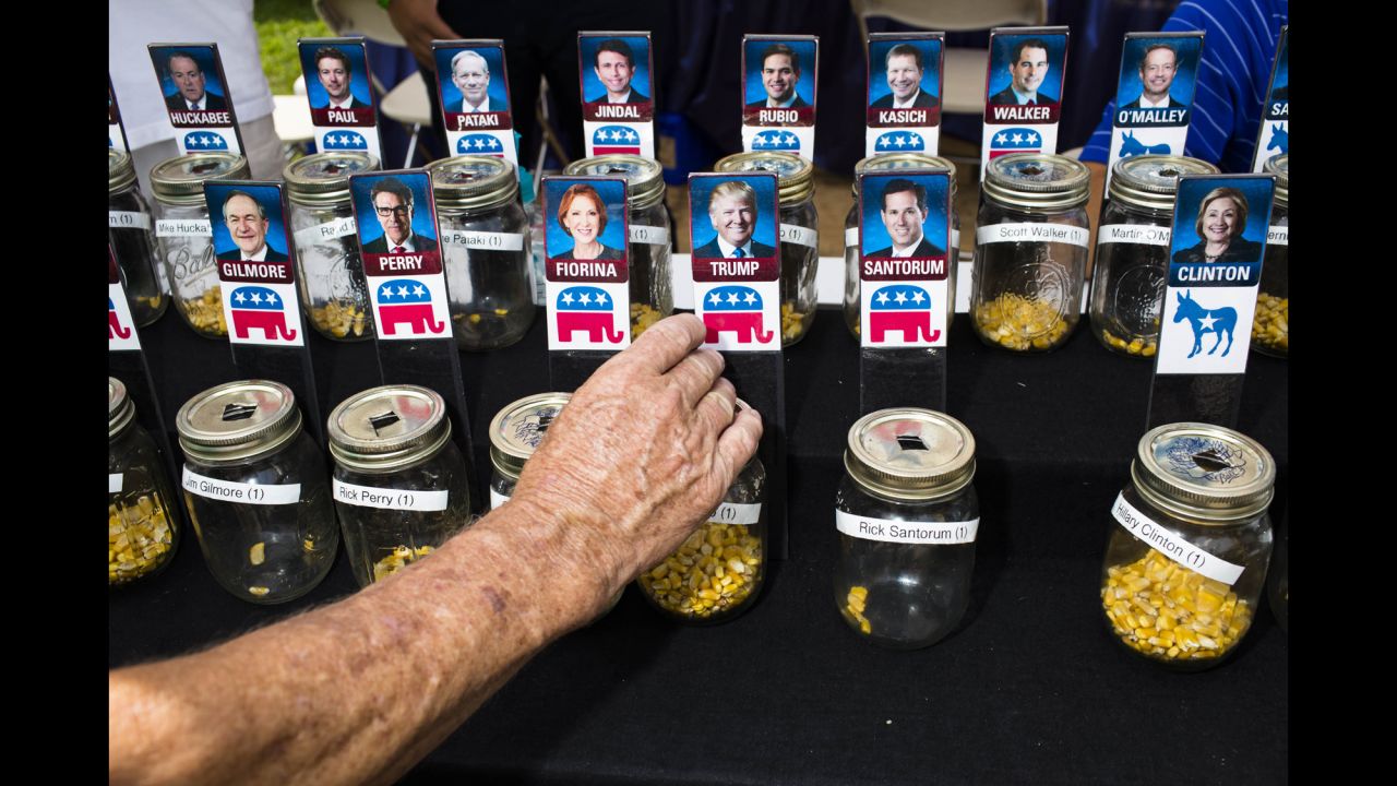 Fairgoers vote for presidential candidates with corn kernels on Thursday, August 13.