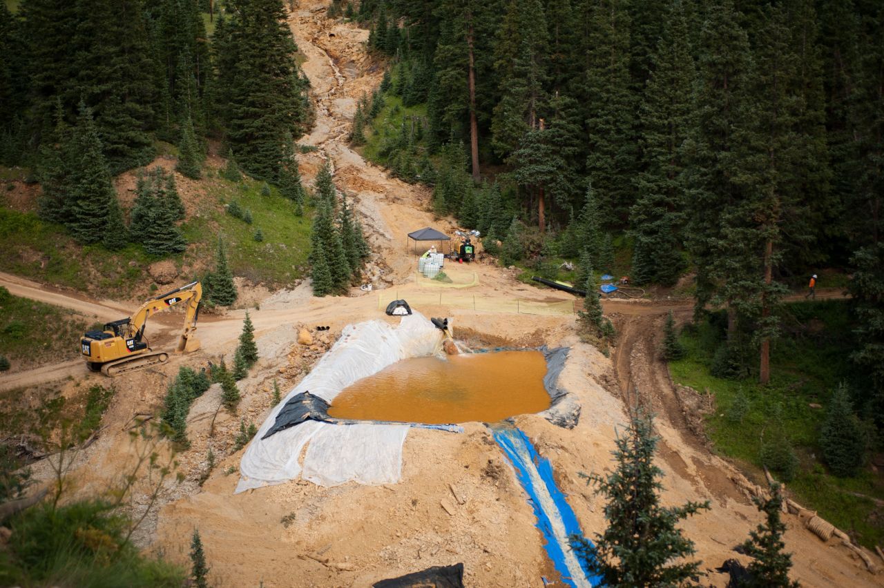 A settling pond is used on Tuesday, August 11, in Silverton, Colorado, at Cement Creek, which was flooded with millions of gallons of mining wastewater.  Settling ponds are used to reduce the acidity of mining wastewater so that it carries fewer heavy metals. 