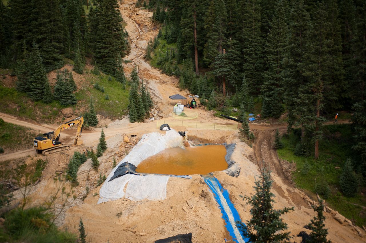 A settling pond is used on Tuesday, August 11, in Silverton, Colorado, at Cement Creek, which was flooded with millions of gallons of mining wastewater. Settling ponds are used to reduce the acidity of mining wastewater so that it carries fewer heavy metals.