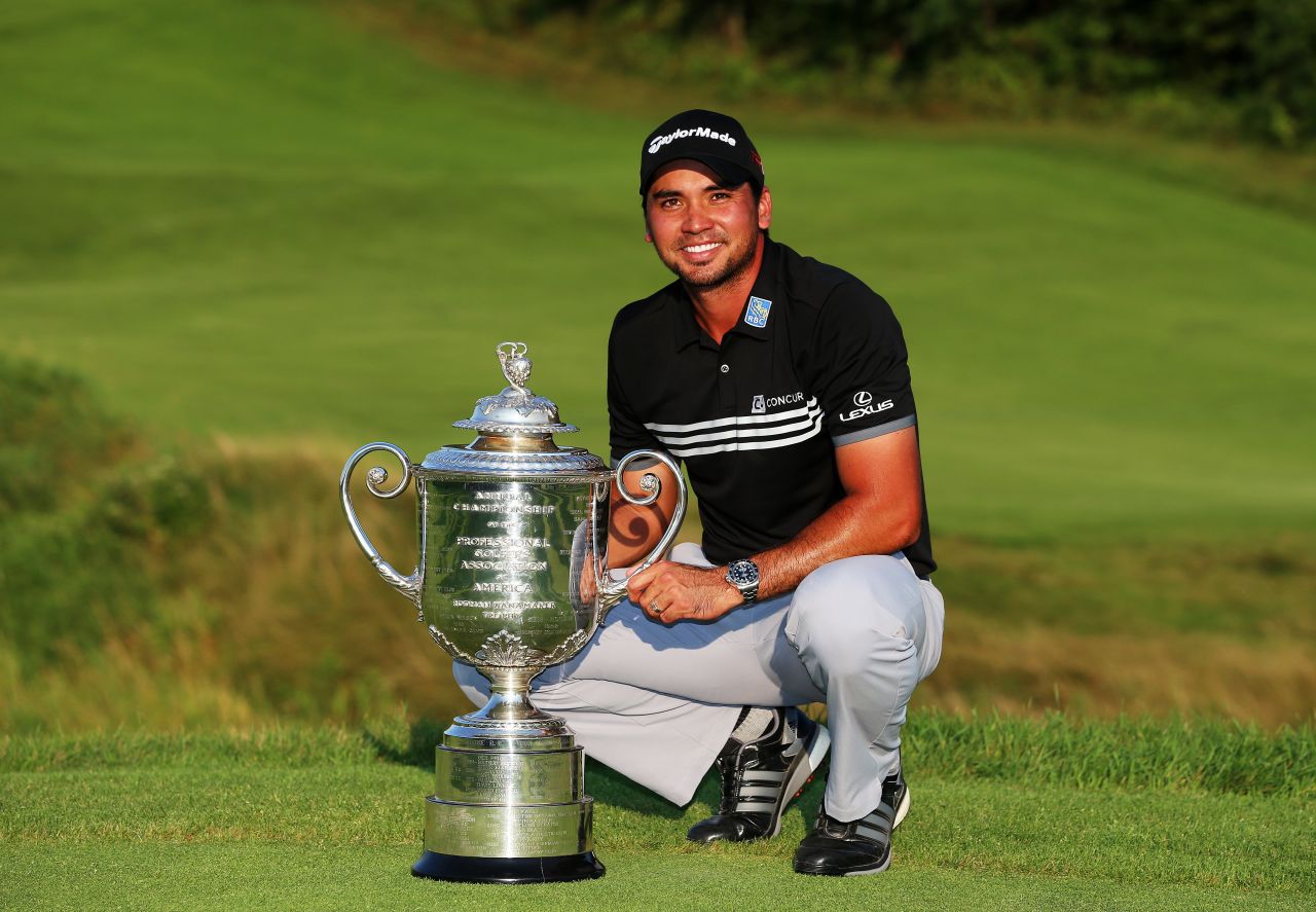 The Australian poses with the Wanamaker trophy after claiming his first major title with a record score of 20 under par.