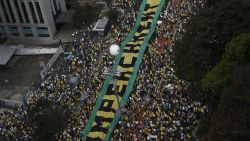 Demonstrators protest against Brazilian President Dilma Rousseff and the ruling Workers Party (PT), at Paulista Avenue in Sao Paulo,  Brazil on August 16, 2015. Protesters took to the streets of Brazil Sunday, kicking off nationwide rallies expected to draw hundreds of thousands demonstrating against corruption and economic slowdown, and calling for President Dilma Rousseff to step down. AFP PHOTO / Miguel SCHINCARIOL        (Photo credit should read Miguel Schincariol/AFP/Getty Images)