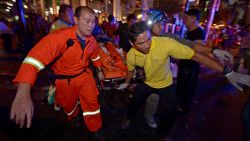 Thai rescue workers carry an injured person after a bomb exploded outside a religious shrine in Bangkok on Monday, August 17.