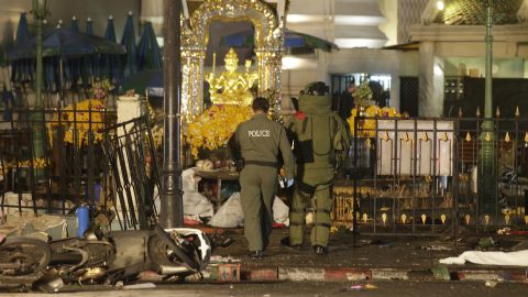 Police enter the Erawan Shrine after the explosion. The shrine sits at a busy intersection, with the city's Skytrain rumbling nearly overhead. 
