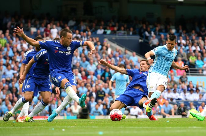 Manchester City's Argentine striker Sergio Aguero wriggles away from four Chelsea defenders to slot his side into the lead.