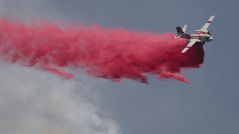 A plane drops fire retardant on the Cabin Fire north of Asuza, California, on Saturday, August 15.