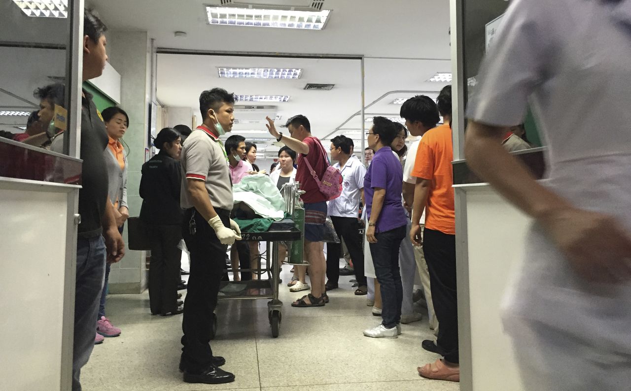 A wounded person lies on a gurney at the Police General Hospital in Bangkok.