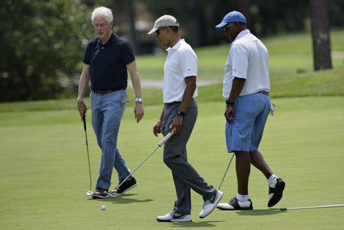 U.S. President Barack Obama plays golf with former President Bill Clinton, left, and former U.S. trade representative Ron Kirk at Farm Neck Golf Club in Oak Bluffs, Massachusetts, on Saturday, August 15.