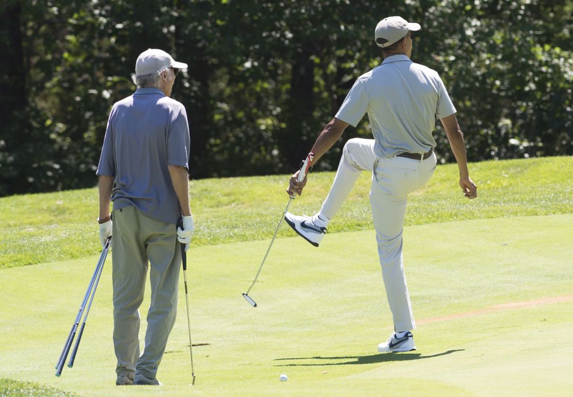 Obama reacts to a putt alongside comedian Larry David as they play golf at Farm Neck Golf Club on Saturday, August 8.
