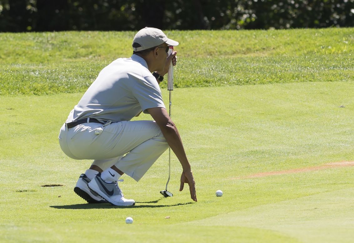Obama lines up a putt as he plays golf on August 8.