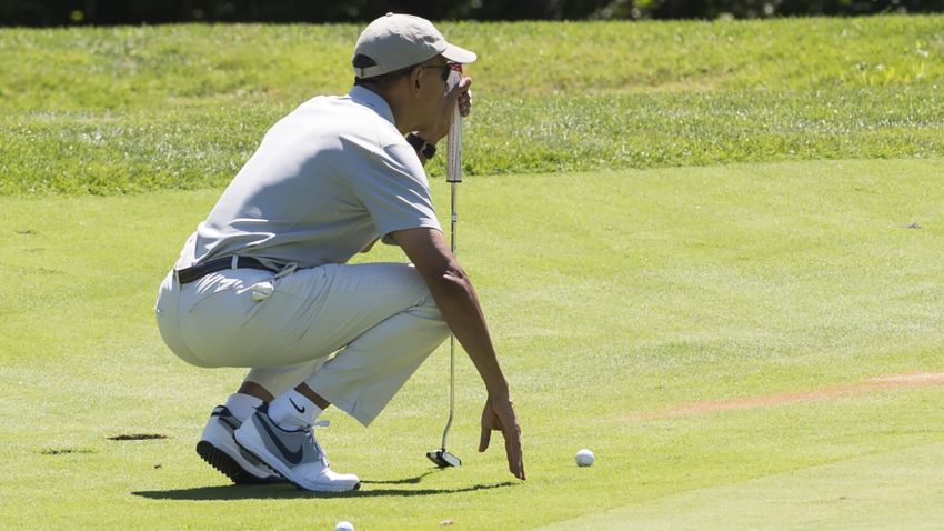 Obama lines up a putt as he plays golf at Farm Neck Golf Club in Oak Bluffs on Martha's Vineyard in Massachusetts, August 8, 2015.