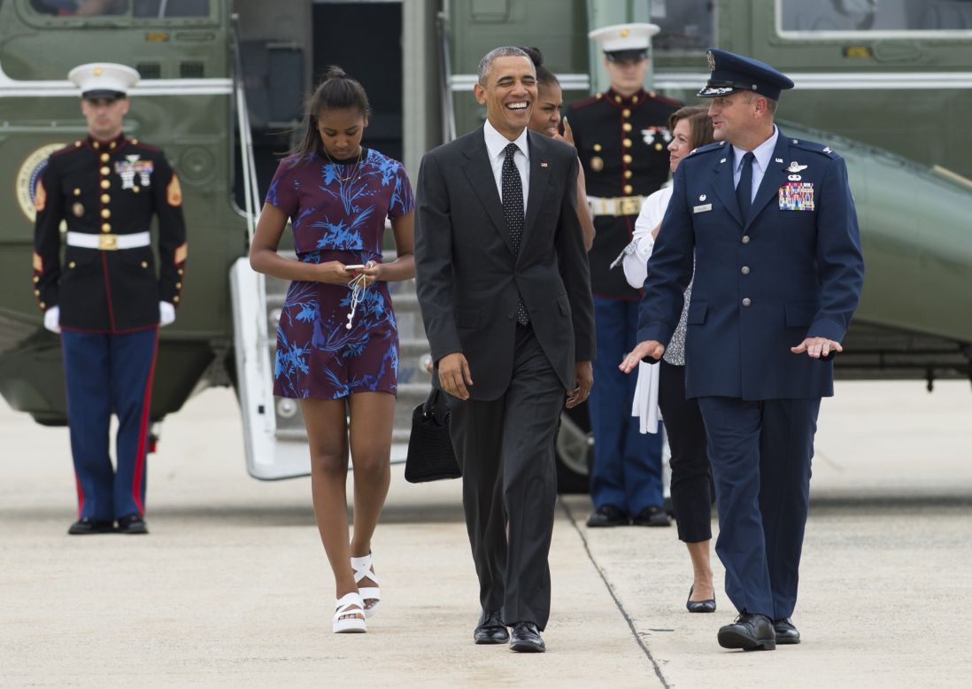 President Obama, first lady Michelle Obama and their daughter Sasha walk to Air Force One prior to leaving Andrews Air Force Base in Maryland on August 7.