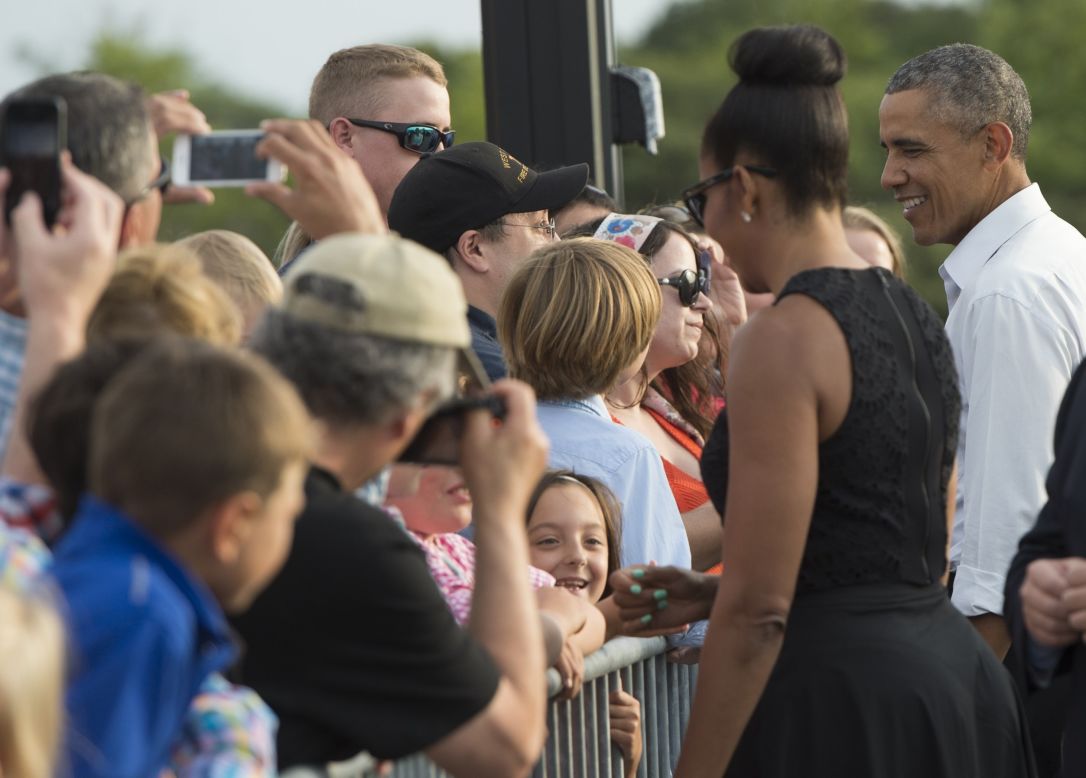 The Obamas greet well-wishers upon arriving at Martha's Vineyard in Massachusetts on Friday, August 7.