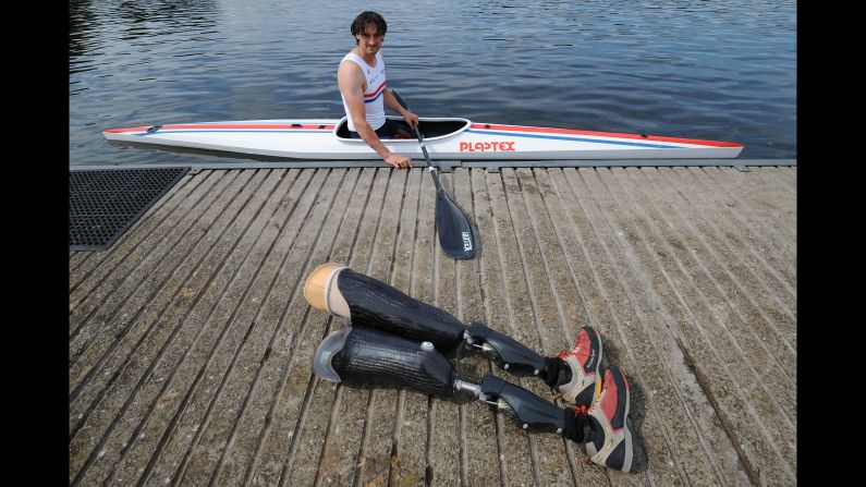 British rower Nick Beighton looks at his prosthetic legs Tuesday, August 11, while training in Nottingham, England, for the Paracanoe World Championships.
