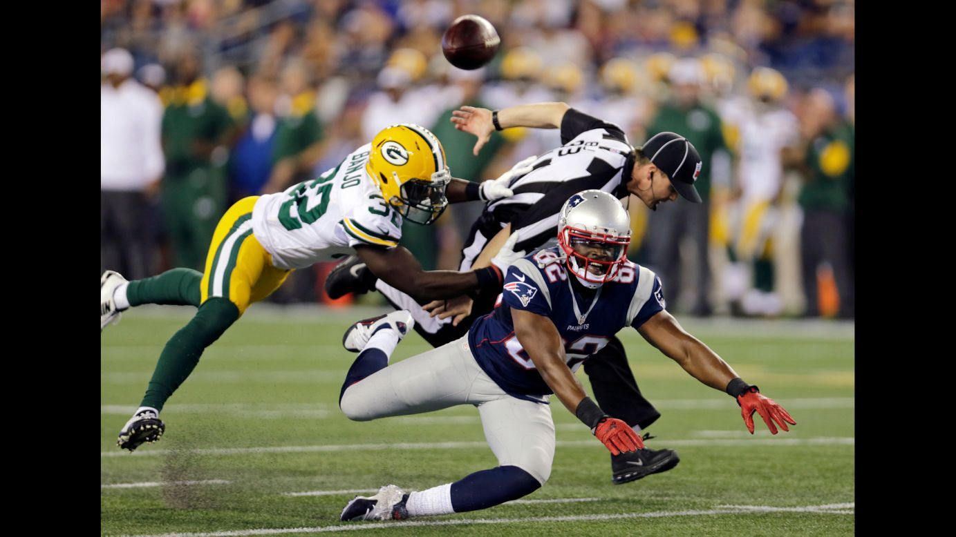 Green Bay Packers safety Chris Banjo breaks up a pass intended for New England Patriots wide receiver Josh Boyce during a preseason game in Foxborough, Massachusetts, on Thursday, August 13. Official Shawn Hochuli got tangled up in the play.