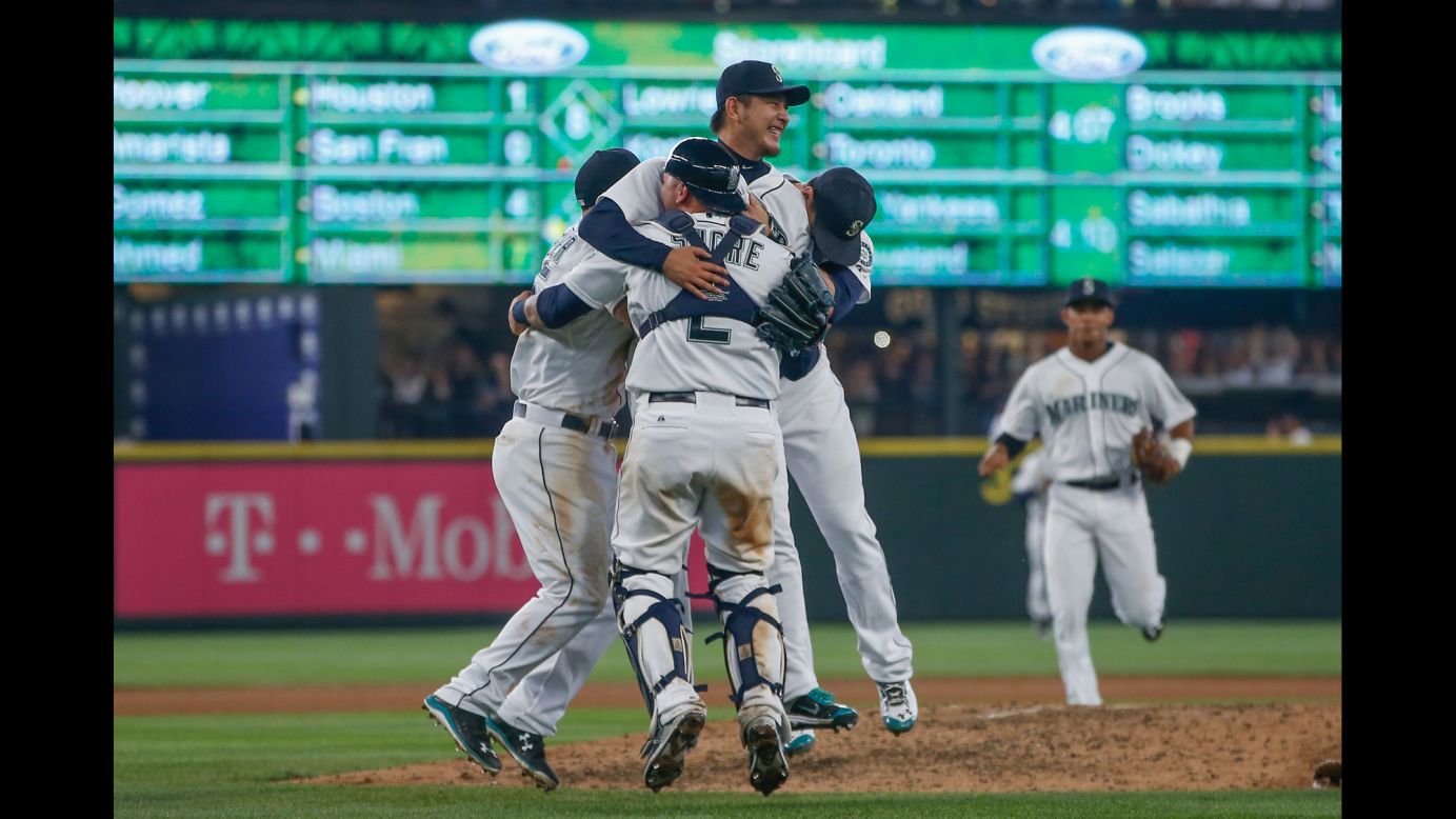 Seattle Mariners pitcher Hisashi Iwakuma is swarmed by teammates after he threw a no-hitter against Baltimore on Wednesday, August 12. Iwakuma is the second Japanese-born player to throw a no-hitter in the majors. Hideo Nomo threw two no-hitters during his career.