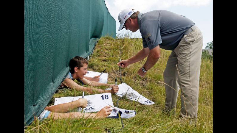Ryan Helminen signs some autographs during a practice round at the PGA Championship on Wednesday, August 12.