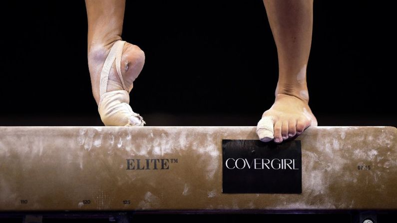 A gymnast warms up on the balance beam at the P&G Gymnastics Championships on Saturday, August 15.