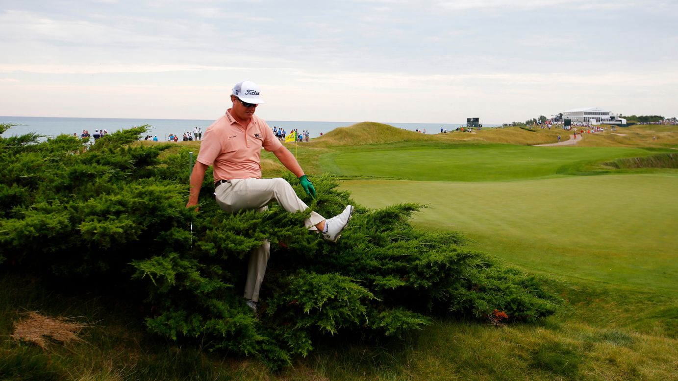 Charley Hoffman searches for his ball during the first round of the PGA Championship on Thursday, August 13. The major tournament was played at the Whistling Straits golf course in Sheboygan, Wisconsin.