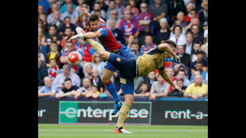 Arsenal's Olivier Giroud, front, vies for the ball with Crystal Palace's Joel Ward during a Premier League match in London on Sunday, August 16. Giroud scored a goal in the match as Arsenal won 2-1.